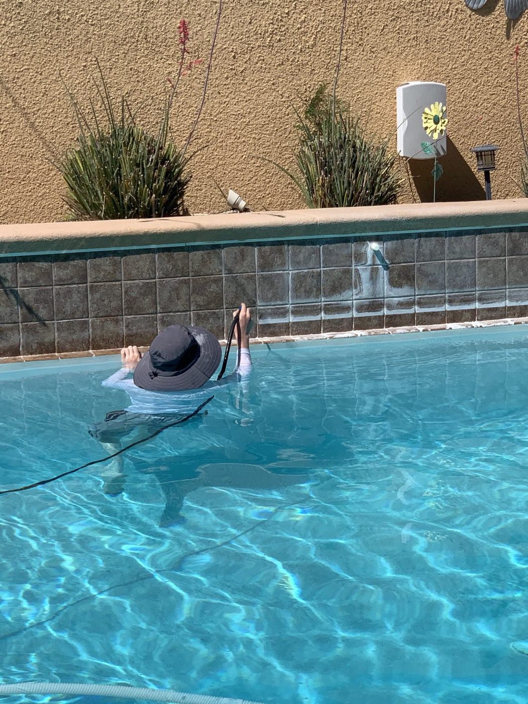 A Poseidon crew member at work in a customer's pool